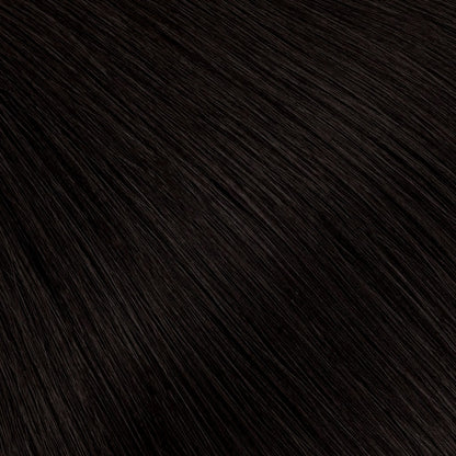 A soft natural black with the faintest warm undertone — richer and more dimensional than pure black, without reading overly dark.
The most wearable dark shade, designed to blend seamlessly across a range of natural hair tones.