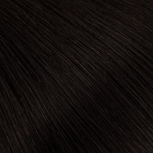 A soft natural black with the faintest warm undertone — richer and more dimensional than pure black, without reading overly dark.
The most wearable dark shade, designed to blend seamlessly across a range of natural hair tones.
